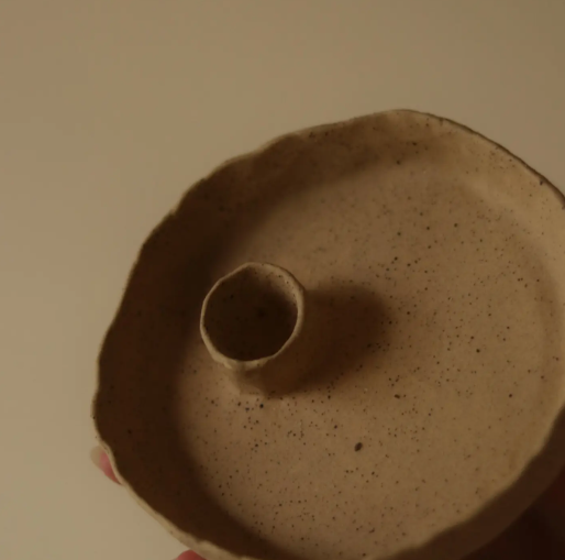 unglazed clay candle holder