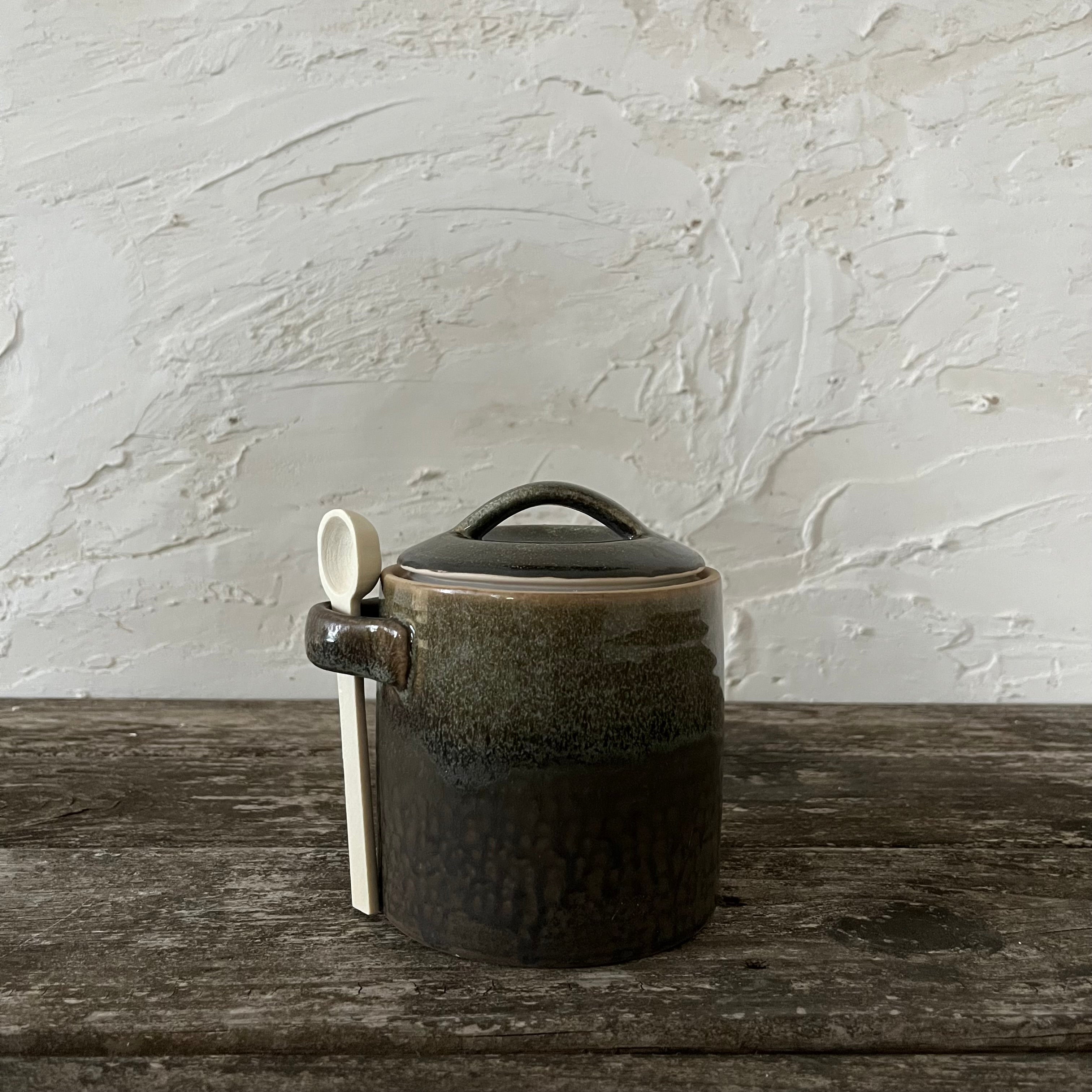 stoneware canister with spoon