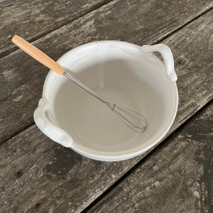 stoneware bowl and wooden whisk