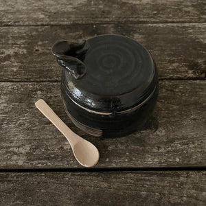 stoneware jar with spoon